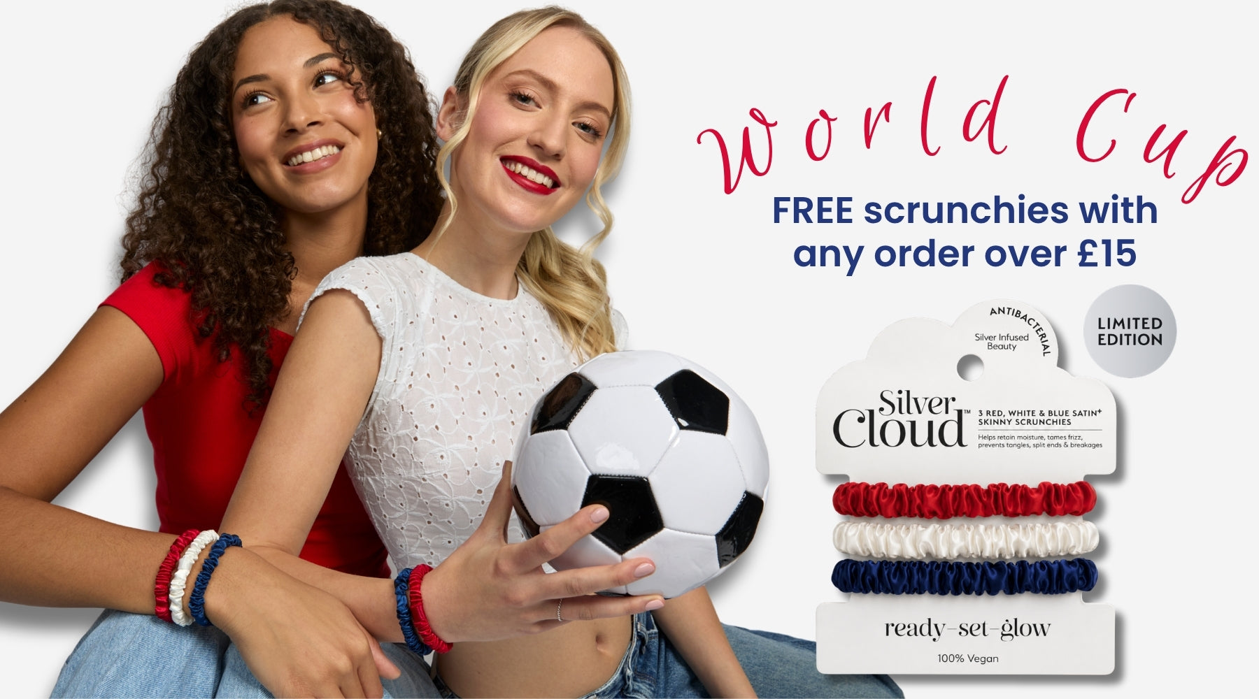 Two smiling women holding a soccer ball next to a package of Silver Cloud World Cup themed scrunchies, with promotional text reading 'World Cup FREE scrunchies with any order over £15'.